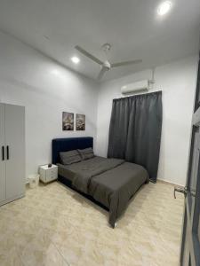 Ένα ή περισσότερα κρεβάτια σε δωμάτιο στο Tok Ayoh Homestay