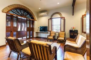 a living room with wicker chairs and a table at FOREST - Fong Lee CC Lampang Walking Street in Lampang +18 photos
