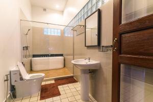 a bathroom with a toilet and a sink and a tub at FOREST - Fong Lee CC Lampang Walking Street in Lampang