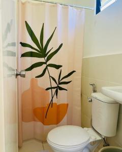 a bathroom with a shower curtain with a plant on it at ACL HOME -Island Staycation in Lapu Lapu City +22 photos
