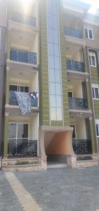 a tall building with blue balconies on it at Bbunga cozy apartment in Kampala