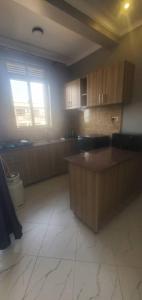 a kitchen with a island in the middle of a room at Bbunga cozy apartment in Kampala
