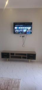 a flat screen tv on a wall in a room at Bbunga cozy apartment in Kampala