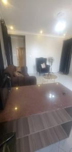a living room with a tub in the middle of a room at Bbunga cozy apartment in Kampala +1 photo
