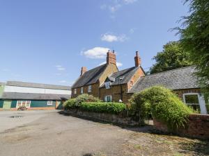 an old brick house with a roof at Hill House Farm in Northampton