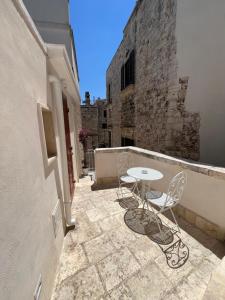 a patio with a table and chairs on a balcony at Borgo Sant Angelo in Conversano