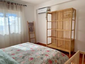 a bedroom with a bed and a book shelf at Casa Luz in Luz