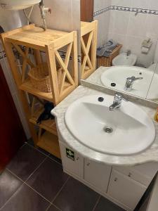a bathroom with a sink and a mirror at Casa Luz in Luz +10 photos