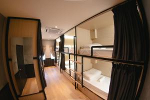 a room with two bunk beds and a hallway at Concrete Jungle Cabin in Kota Kinabalu +81 photos
