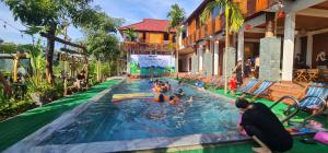 a group of people in a swimming pool at a resort at Homestay Blackpink 1986 in Xóm Trương Quít +10 photos