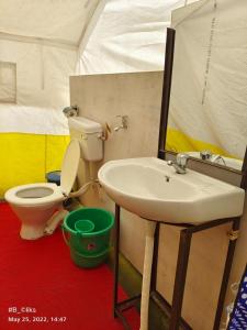 a bathroom with a sink and a toilet in a tent at Lake Valley Camp Ladakh by LexStays in Leh