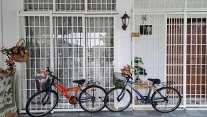 three bikes parked in front of a window at Good Old Days Butterworth Homestay near Raja Uda in Butterworth
