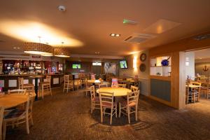 a restaurant with tables and chairs and a bar at Skipsea sands Northfield corner in Ulrome