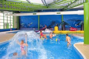 a group of children playing in a swimming pool at Skipsea sands Northfield corner in Ulrome