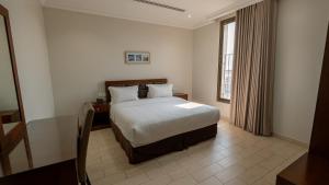 a hotel room with a bed and a window at شركة حديقة لينا للشقق المخدومة - 5 in Al Khobar +44 photos
