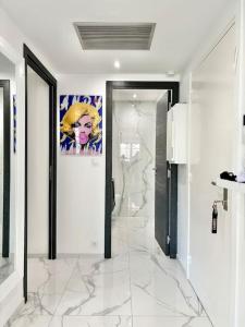 a hallway with marble floors and a painting on the wall at Gray D'Albion -2A8- 1 Chambre in Cannes +9 photos