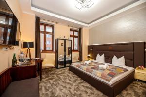 a bedroom with a large bed in a room at Wellness Hotel Beethoven in Chomutov