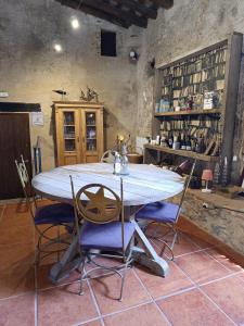 a dining room with a table and some chairs at Mas Del Llop Blanc - Dog friendly Hostal Rural - B&B in Sobrestany