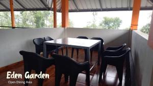a black table and chairs in a room at Eden Gardens Vagamon in Vagamon