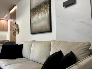 a living room with a couch and a painting on the wall at Zlatibor Wayout, Spa & Wellness in Zlatibor