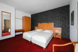 Postel nebo postele na pokoji v ubytování Hotel Mirage