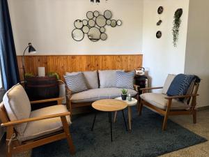 a living room with a couch and two chairs and a table at Het Hongaarse Wijnhuis in Mohács +15 photos