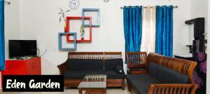 a living room with two couches and a tv at Eden Gardens Vagamon in Vagamon