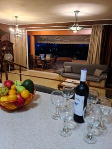 a bottle of wine sitting on a table with wine glasses at StarLight SeaView in Gouvia +24 photos