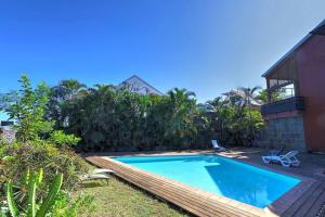 a swimming pool in the backyard of a house at Ylang Ylang - apt T3 la Saline les Bains in Saint-Paul