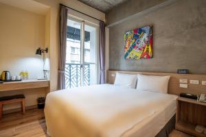 En eller flere senger på et rom på CHECK inn Express Taichung Yizhong
