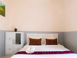 Postel nebo postele na pokoji v ubytování Guest House 88 Pandawa