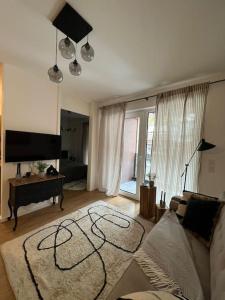 a living room with a couch and a tv at City-Juwel - Luxus Ferienwohnung in Heinsberg