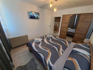 a bedroom with a large bed in a room at Hedonic apartment in Ćuprija