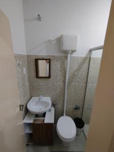 a bathroom with a white toilet and a sink at Apto 5 ótimo local proximo shopping in Campo Grande