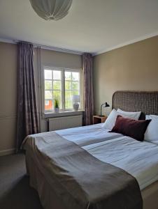 Säng eller sängar i ett rum på Brunnsvik Hotell & Konferens +15 foton