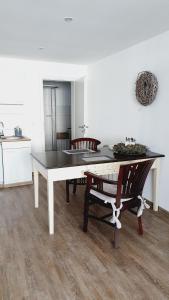 a dining room with a table and two chairs at Ferienwohnungen Naturzeit in Willingen