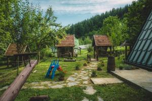 a playground with a slide and a swing set at Mountain house"LISIN"Bradina Konjic in Konjic