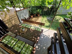 a patio with a table and benches in a backyard at FRIZ&FANY Postojna City Center in Postojna