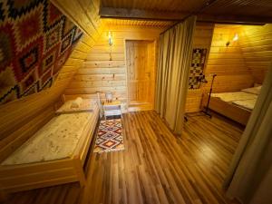 a room with two beds in a wooden cabin at Słoneczne Wzgórze w Kojszówce in Kojszówka +17 photos
