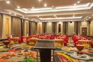 a banquet hall with red chairs and tables in it at Aston Gorontalo Hotel & Villas in Gorontalo +35 photos