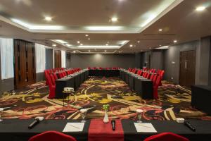 a conference room with red chairs and a large carpet at Aston Gorontalo Hotel & Convention Center in Gorontalo