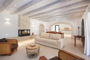 a living room with a couch and a fireplace at Finca Ses Rotes in Cala Ferrera