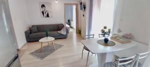 a living room with a couch and a table at Iulius Mall Area Apartament in Iaşi