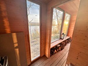 a screened in porch with two windows and a bench at Tana Panorama - Apartments in Tana