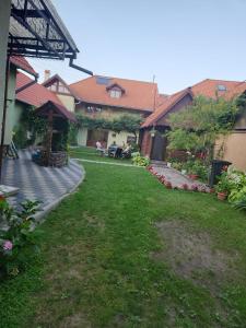 a backyard of a house with a grass yard at CASA Maria in Orlat +21 photos