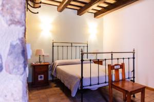 Un dormitorio con una cama, una mesa y una silla. en Agroturisme Sant Dionis, en Campllong