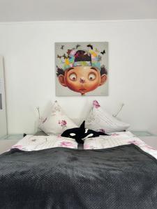 a bed with a black cat laying on top of it at Appartement am Teich in Krefeld