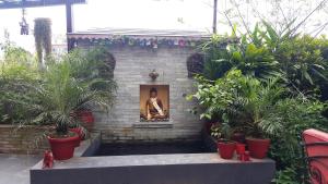 a statue of a man in a picture in a garden at Hotel Middle Path & Spa in Pokhara