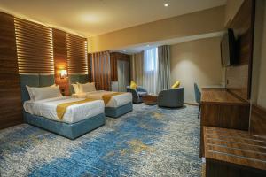 Postel nebo postele na pokoji v ubytování Almsakn Alola Hotel Company
