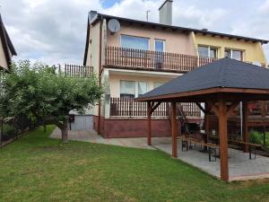 a house with a gazebo in front of it at Haus in der ruhigen Siedlung in Sztum